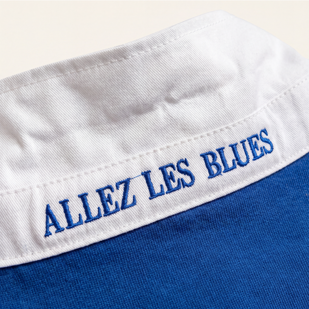 Close-up of 'Allez les Bleus' embroidered under the collar of the Rugby Culture France Rugby Polo