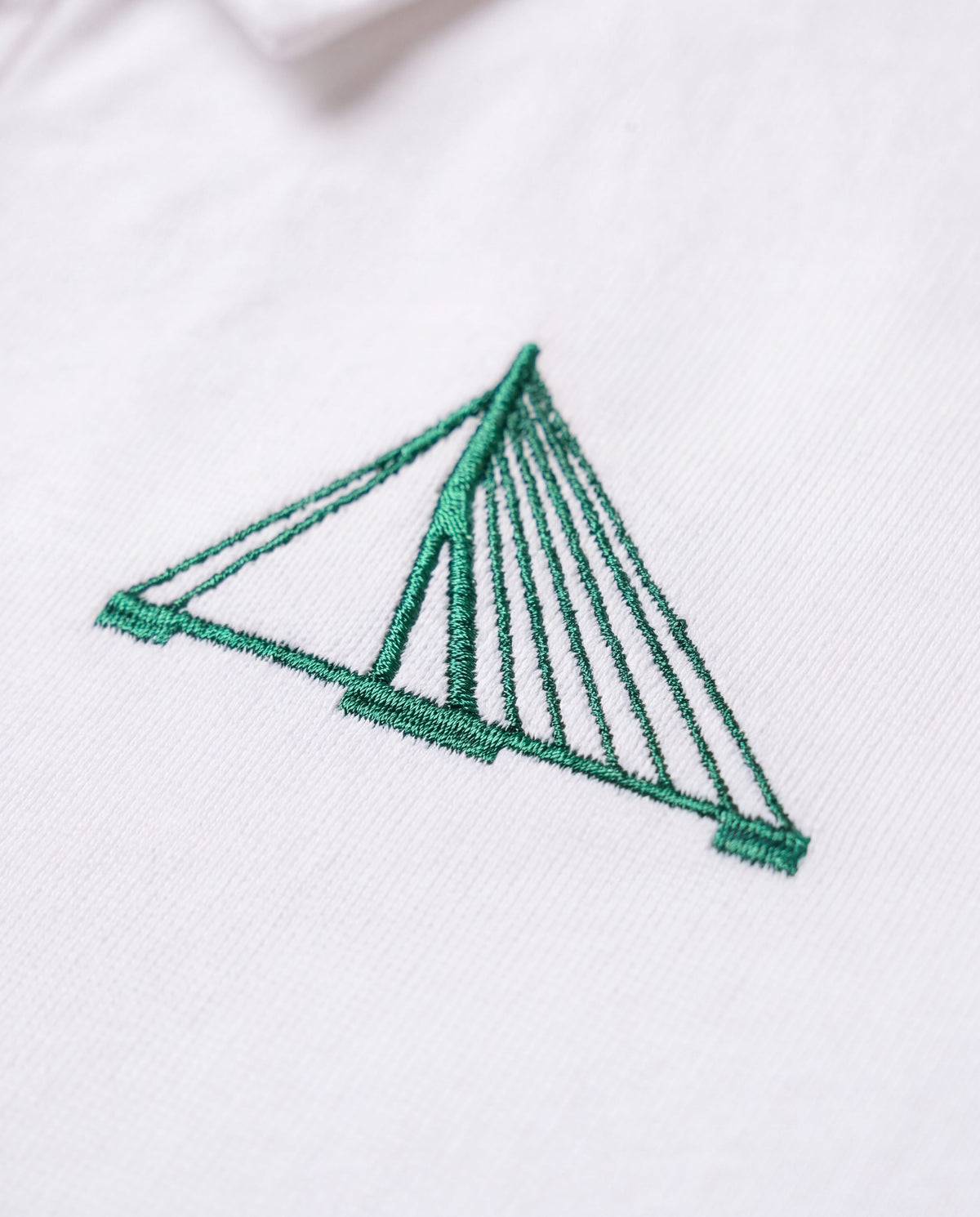 Close-up of the green embroidered Erasmusbrug on the Rotterdam Heritage Rugby Polo