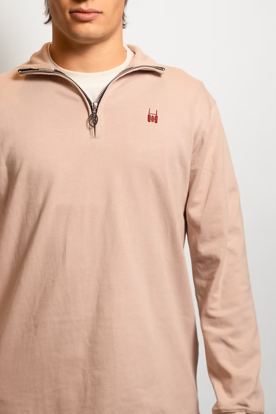 Rugby Culture Beige Quarter-Zip worn by a male model, close-up front view