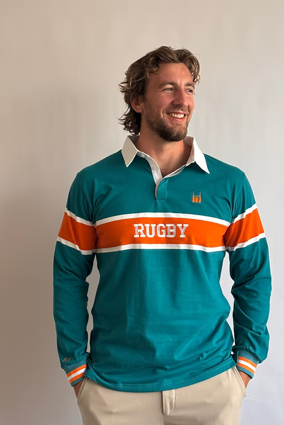 Male model wearing the Rugby Culture Teal & Orange Rugby Polo with orange shorts, front view