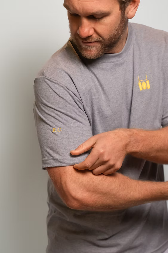 Rugby Culture Grey Basic Logo T-Shirt worn, close-up with arms crossed