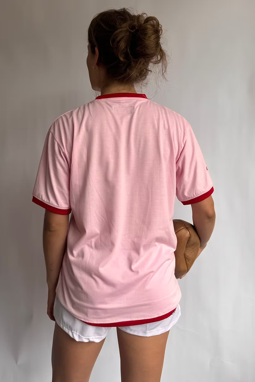 Rugby Culture Pink & Red Logo T-Shirt worn by a female model, back view