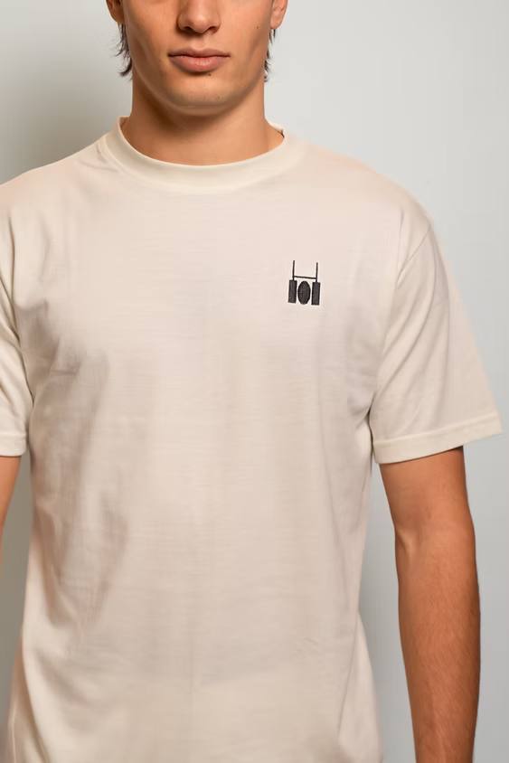 Rugby Culture Eggshell Basic Logo T-Shirt worn by a male model, close-up front view