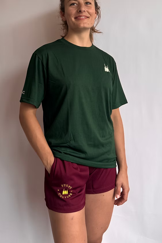 Model wearing Rugby Culture Maroon Scrum Shorts with a green T-shirt, front view