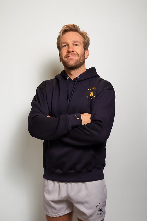 Rugby Culture Navy Blue Hoodie worn by a male model, front view