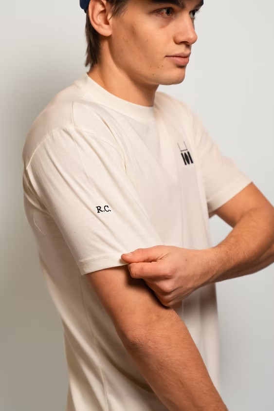 Rugby Culture Eggshell Basic Logo T-Shirt worn, side view showing the sleeve
