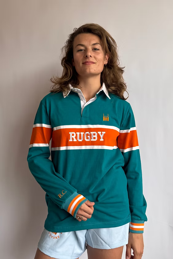 Female model wearing the Rugby Culture Teal & Orange Rugby Polo, front view