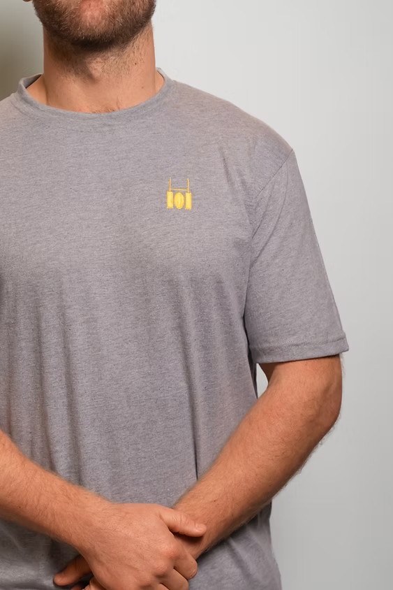 Rugby Culture Grey Basic Logo T-Shirt worn by a male model with arms crossed, close-up