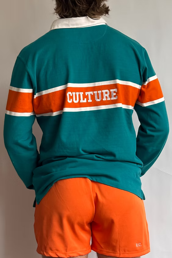 Rugby Culture Teal & Orange Rugby Polo worn, back view with 'CULTURE' across the back band