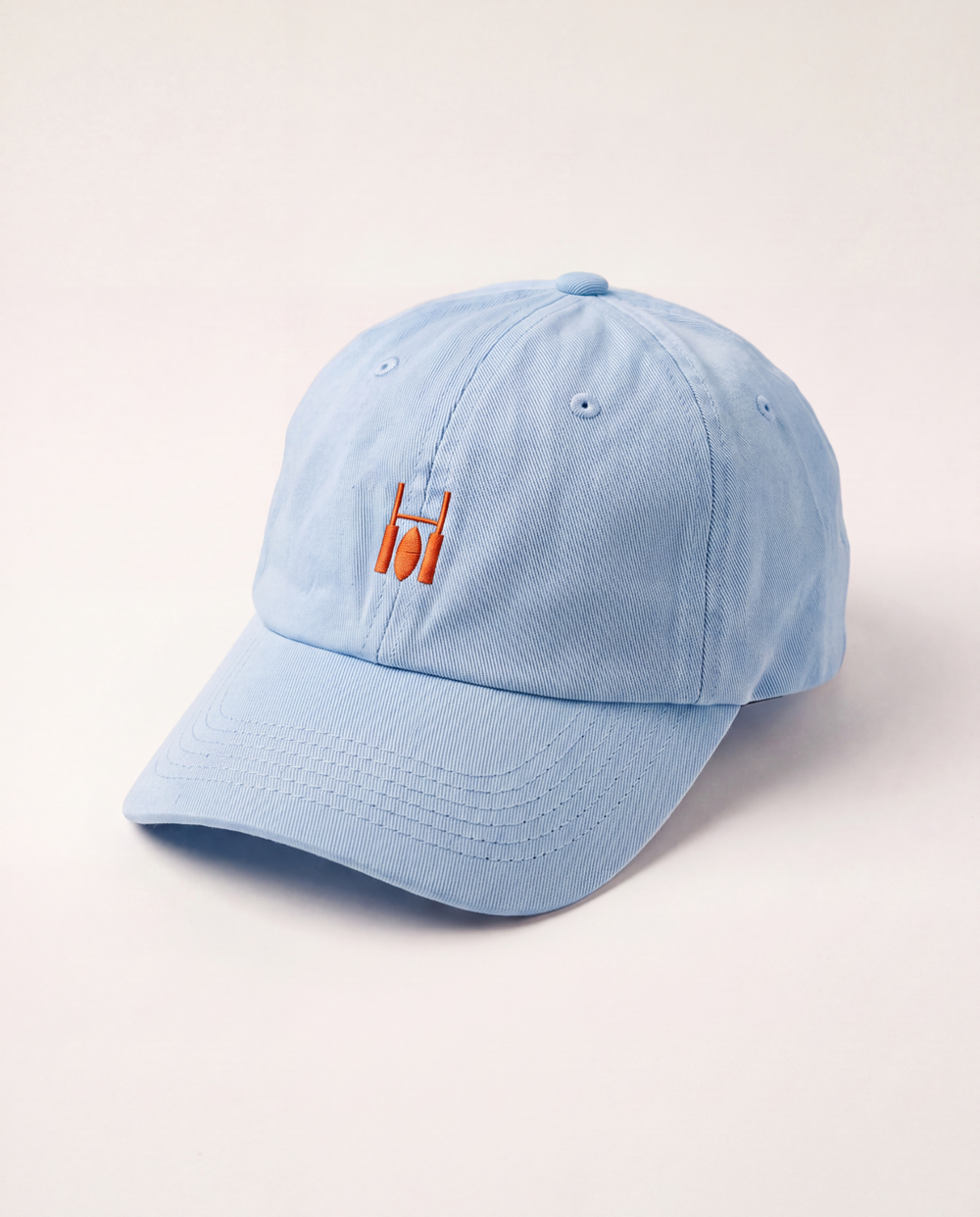 Rugby Culture Sky Blue & Orange Cap, front view with orange embroidered goalpost logo